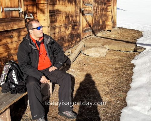 Winter activities in Grindelwald, Krisztian taking a break in front of a wooden mountain hut