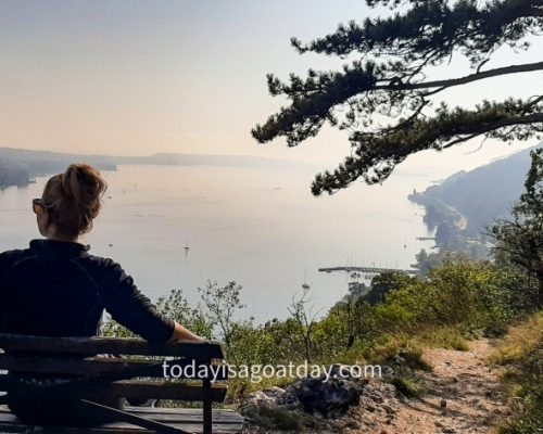 Hiking in Biel, woman sitting on a bench and enjoying the view of Lake Biel