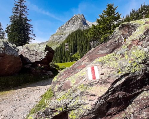 Hiking in Glarus, swiss hiking sign on rock