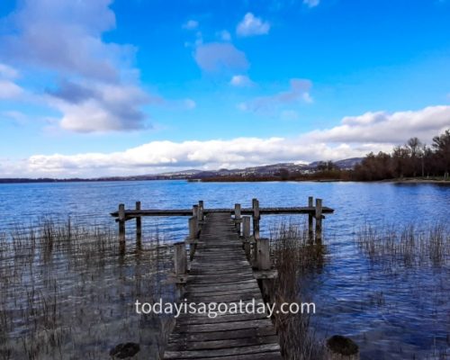 Hiking in canton Zurich, landing stage with blue sky in the background of Pfäffikersee