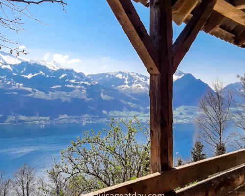 Hiking in canton Schwyz, Lake lucerne viewed through a wooded covered gate