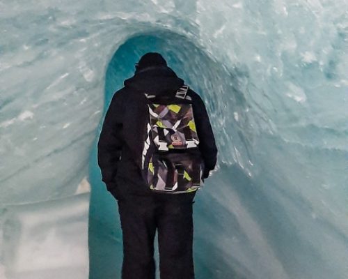 Top attraction in Switzerland, Krisztian walking into an ice tunnel in the Ice Palace