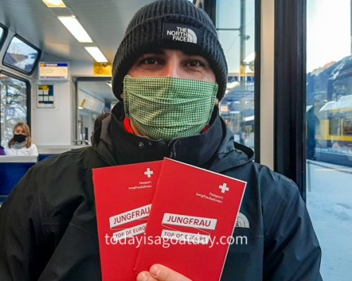 Top attraction in Switzerland, Krisztian sitting on the train holding Jungfraujoch passports