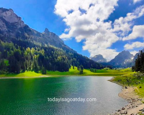 greta hike in Appenzell, Sämtisersee, green lake with blue sky and scattered clouds, Alpstein