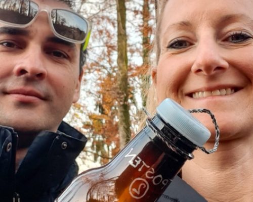 Activity in canton Aargau, couple holding bottle with clue during scavenger hunt in Villingen