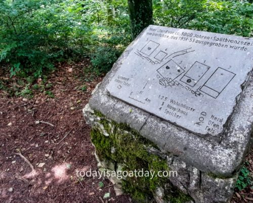 Hiking in Aargau, stone signage board for a prehistoric site in the forest, Chestenberg round trek