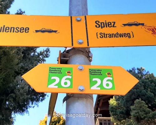 Great hikes in Spiez, yellow Spiez Strandweg signage on the beach trail