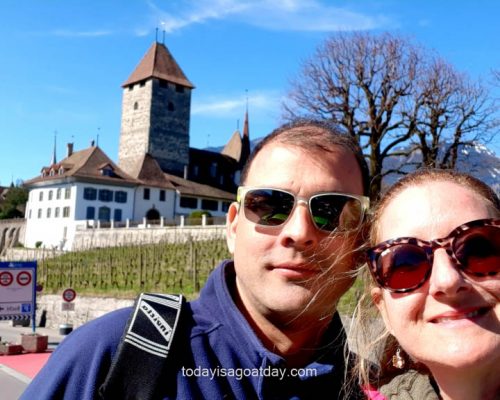 Top hiking trails around Spiez, man sitting on bench and enjoying the sun in from of the entrance to a wine cellar