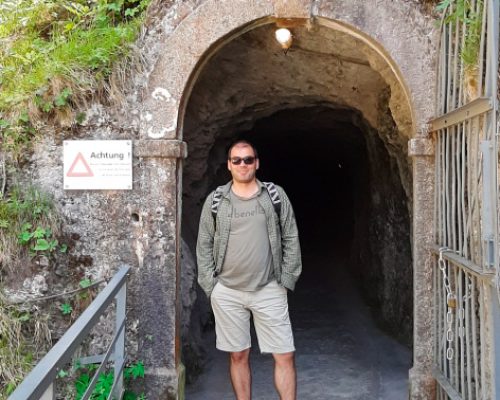 The best things to do in Meiringen, west entrance to Aareschlucht, man standing in fron of the tunnel entrance